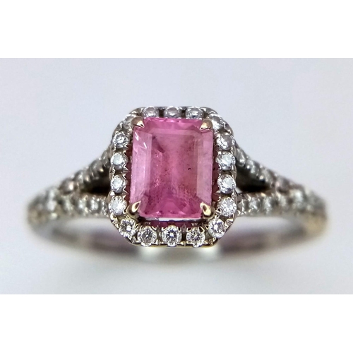 38 - A Beaverbrooks Pink Sapphire and Diamond Ring. Central gemstone with a diamond halo and accents. Siz... 