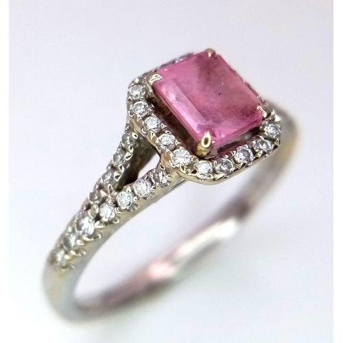 38 - A Beaverbrooks Pink Sapphire and Diamond Ring. Central gemstone with a diamond halo and accents. Siz... 