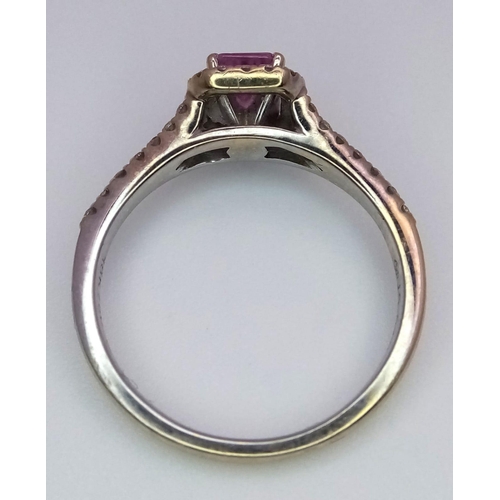 38 - A Beaverbrooks Pink Sapphire and Diamond Ring. Central gemstone with a diamond halo and accents. Siz... 