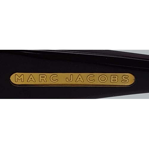 521 - Beautiful pair of Marc Jacobs Purple Sunglasses.
Made in Italy. Big bold frame with funky gemmed lov... 