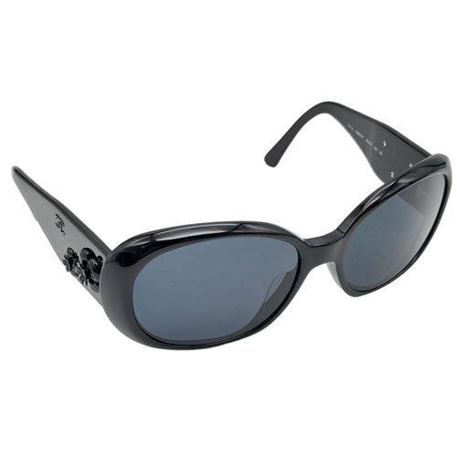 556 - Black Chanel Sunglasses with Floral Motifs. 
Built to be worn whilst driving a small convertible car... 