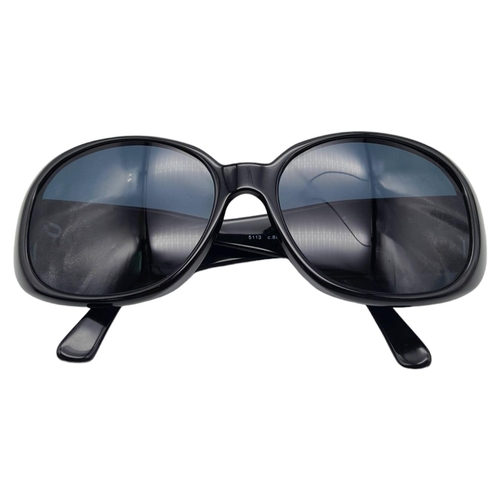 556 - Black Chanel Sunglasses with Floral Motifs. 
Built to be worn whilst driving a small convertible car... 