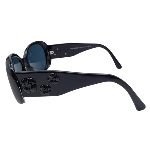 556 - Black Chanel Sunglasses with Floral Motifs. 
Built to be worn whilst driving a small convertible car... 