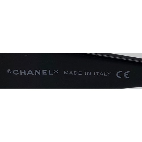 556 - Black Chanel Sunglasses with Floral Motifs. 
Built to be worn whilst driving a small convertible car... 