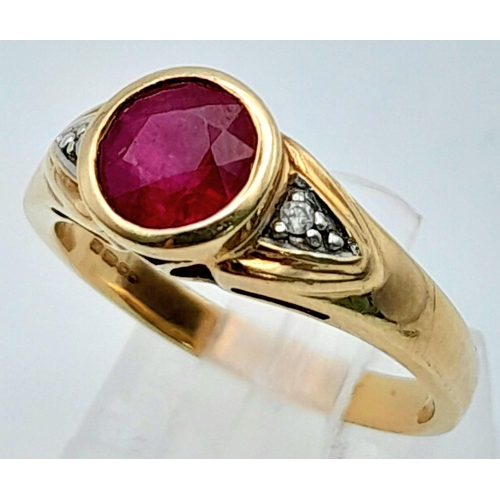 565 - A 9K YELLOW GOLD DIAMOND & RED STONE RING. Size N, 3.2g total weight.