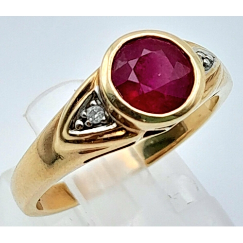 565 - A 9K YELLOW GOLD DIAMOND & RED STONE RING. Size N, 3.2g total weight.