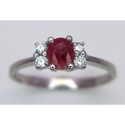 670 - A PLATINUM DIAMOND & RUBY RING. Size M, 2.7g total weight.