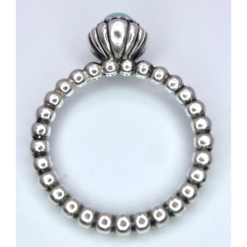 1033 - A STERLING SILVER PANDORA TURQUISE DECEMBER BIRTH STONE RING. Size O or 56, 3.7g total weight.