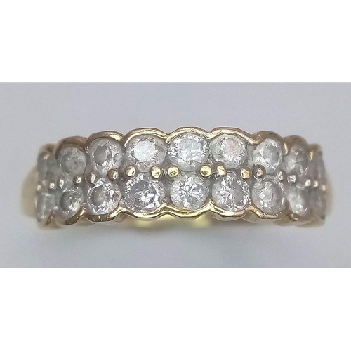 537 - A 9K YELLOW GOLD DOUBLE ROW DIAMOND RING. Size S, 0.70ctw, 3g total weight.