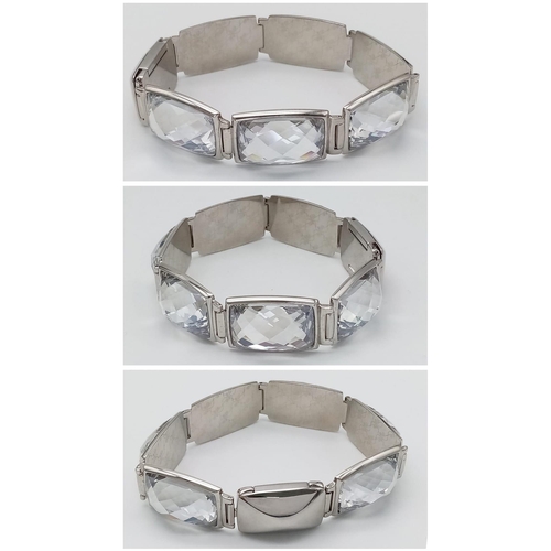 571 - A Stunning Swarovski Rhodium Plated ‘Nirvana-model 1166714’ Crystal
Bracelet. 19.5cm Length, 1.8cm W... 