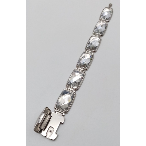 571 - A Stunning Swarovski Rhodium Plated ‘Nirvana-model 1166714’ Crystal
Bracelet. 19.5cm Length, 1.8cm W... 