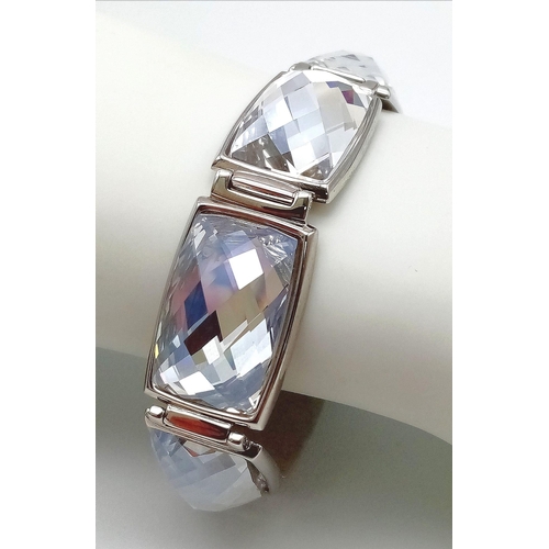 571 - A Stunning Swarovski Rhodium Plated ‘Nirvana-model 1166714’ Crystal
Bracelet. 19.5cm Length, 1.8cm W... 