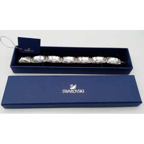 571 - A Stunning Swarovski Rhodium Plated ‘Nirvana-model 1166714’ Crystal
Bracelet. 19.5cm Length, 1.8cm W... 