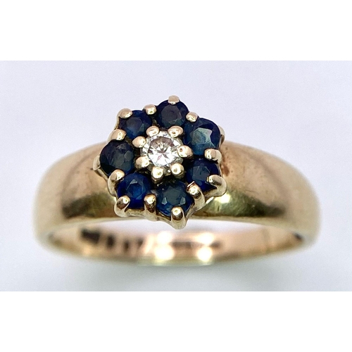 613 - A 9K YELLOW GOLD DIAMOND & SAPPHIRE CLUSTER RING. Size N, 2.1g total weight.