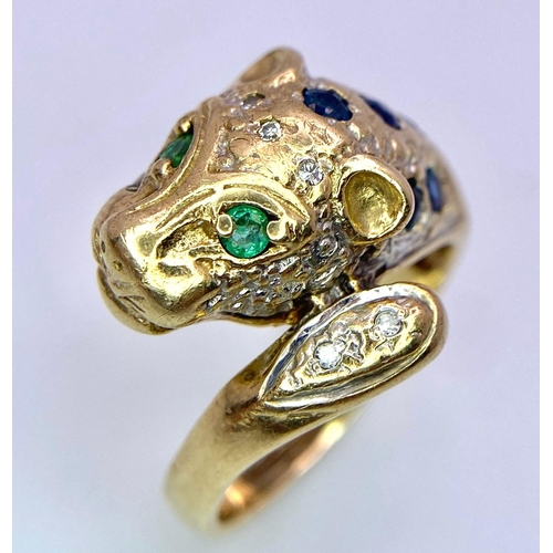 642 - A 9K GOLD DIAMOND , SAPPHIRE AND EMERALD SET PANTHER RING .   4.8gms   size J