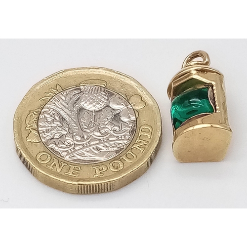 715 - A 9K YELLOW GOLD GREEN STONE SET LANTERN. 2cm length, 1.5g total weight.