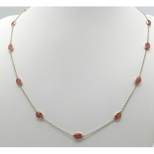 729 - A STERLING SILVER NECKLACE SET WITH 13 OVAL CUT RUBIES. 48cm length, 4.1g total weight.