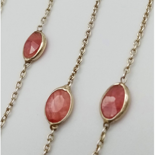 729 - A STERLING SILVER NECKLACE SET WITH 13 OVAL CUT RUBIES. 48cm length, 4.1g total weight.