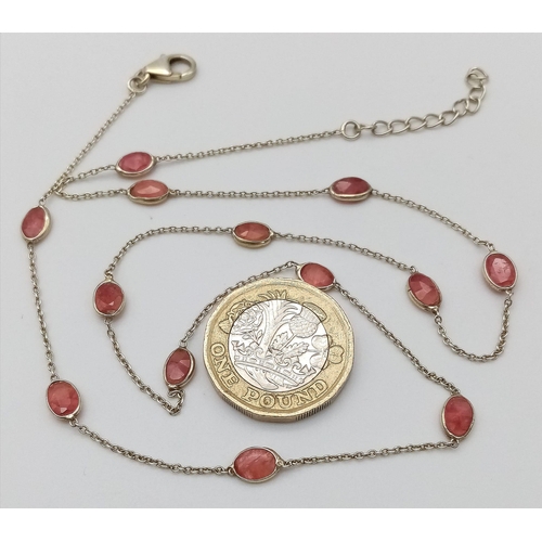 729 - A STERLING SILVER NECKLACE SET WITH 13 OVAL CUT RUBIES. 48cm length, 4.1g total weight.