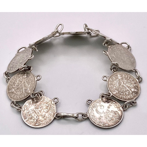 957 - A SILVER COIN BRACELET SET WITH 9 THREE PENCE PIECES. DATE RANGES 1912 TO 1940. 18.5CM LENGTH, 15.8G... 