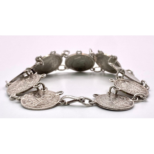 957 - A SILVER COIN BRACELET SET WITH 9 THREE PENCE PIECES. DATE RANGES 1912 TO 1940. 18.5CM LENGTH, 15.8G... 