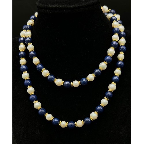 381 - A Lapis Lazuli and Cultured Pearl Matinee Necklace. 8mm beads and pearls. Gilded spacers and clasp. ... 