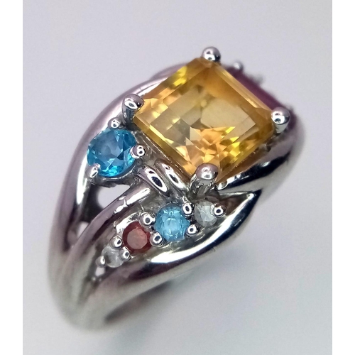 1017 - A Sterling Silver Multi- Semi Precious Gemstone Set Ring Size O. The ring is
set with a Centre 6mm S... 