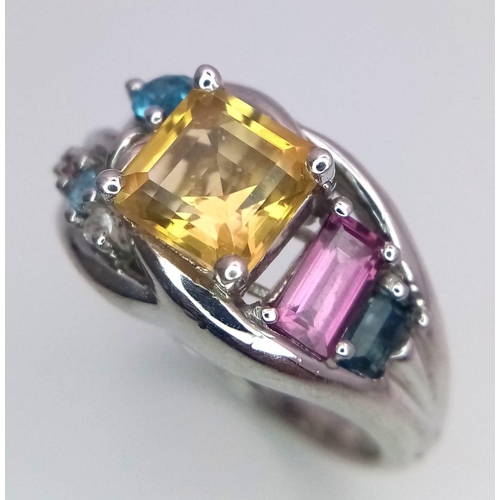 1017 - A Sterling Silver Multi- Semi Precious Gemstone Set Ring Size O. The ring is
set with a Centre 6mm S... 