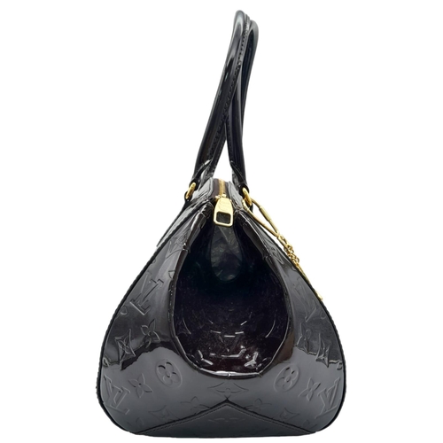 185 - Louis Vuitton Sherwood PM Shoulder Bag.
Features a Purple Monogrammed Patent Leather exterior with G... 