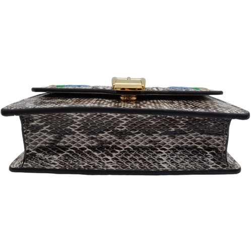 25 - Gucci Snakeskin Leather, Floral Embodied Bag.
This versatile bag can be carried as a clutch or a sho... 