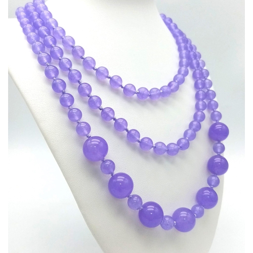 934 - A Rope Length Graduated Purple Jade Bead Necklace. Perfect for different wearing arrangements. 142cm... 