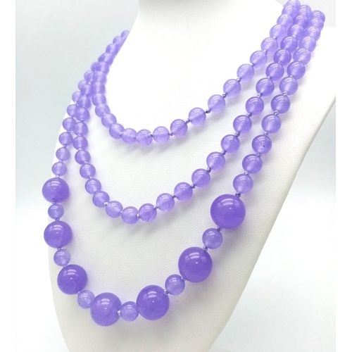 934 - A Rope Length Graduated Purple Jade Bead Necklace. Perfect for different wearing arrangements. 142cm... 