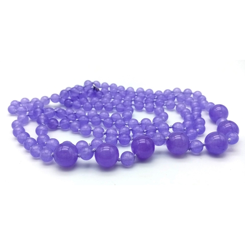 934 - A Rope Length Graduated Purple Jade Bead Necklace. Perfect for different wearing arrangements. 142cm... 