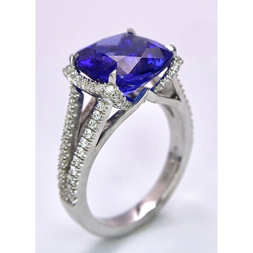 83 - A BESPOKE 18K WHITE GOLD TANZANITE & DIAMOND RING, SET WITH AAA QUALITY CUSHION CUT 6.17CT TANZANITE... 