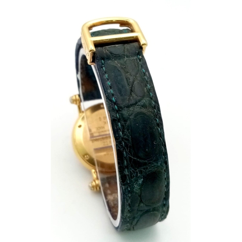 866 - An 18K Gold and Diamond Cartier Ladies Watch. Leather strap with Cartier gold clasp. Circular gold a... 