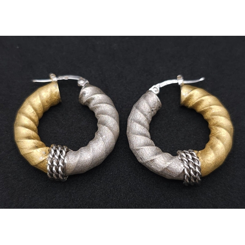 561 - Pair of 18k 2 colour gold twist hoops earrings, (2.8cm diameter) 8.1g