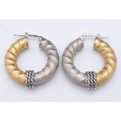 561 - Pair of 18k 2 colour gold twist hoops earrings, (2.8cm diameter) 8.1g