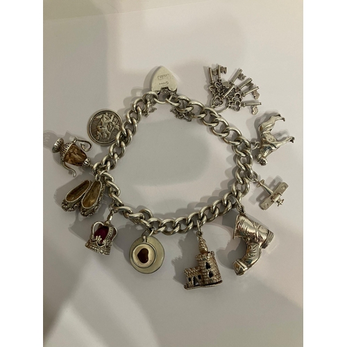 574 - Vintage SILVER CHARM BRACELET Having some interesting and unusual Silver charms to include: Fancy ba... 