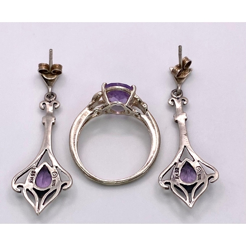 1398 - A matching set of fancy Amethyst jewellery include a pair of earrings & a solitaire ring (Size O). T... 