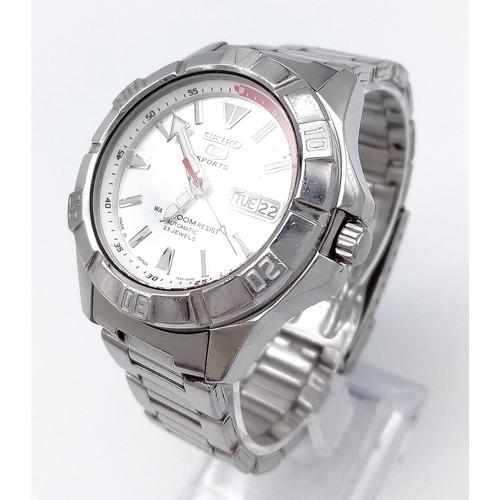 1494 - A Seiko 5 Sports Automatic Gents Watch. Stainless steel bracelet and case - 40mm. Silver tone dial w... 