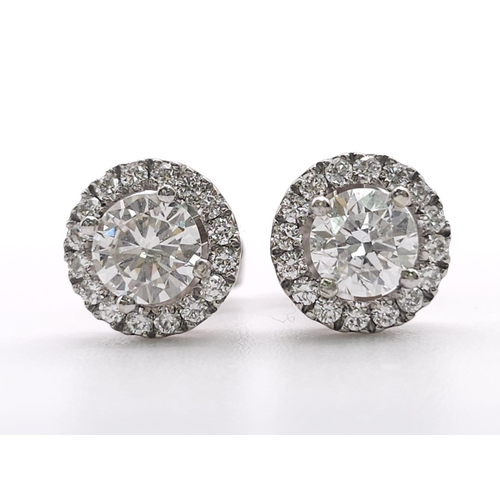 232 - PAIR OF 18K WHITE GOLD DIAMOND HALO STUD EARRINGS, WITH 1.20CT MAIN ROUND BRILIANT CUT STONES, AND F... 