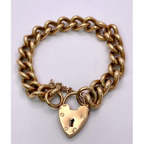 31 - A Vintage 9K Yellow Gold Chunky Curb Link Bracelet with a Heart Clasp. 58g total weight. 17cm.