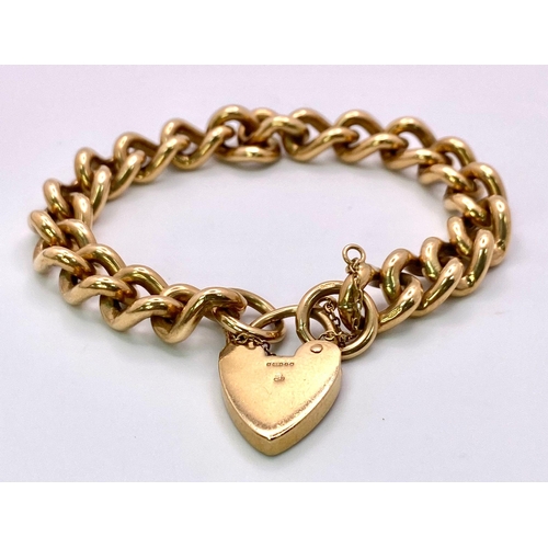 31 - A Vintage 9K Yellow Gold Chunky Curb Link Bracelet with a Heart Clasp. 58g total weight. 17cm.