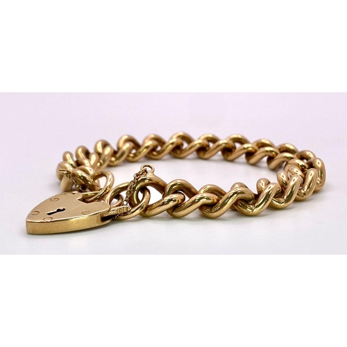 31 - A Vintage 9K Yellow Gold Chunky Curb Link Bracelet with a Heart Clasp. 58g total weight. 17cm.