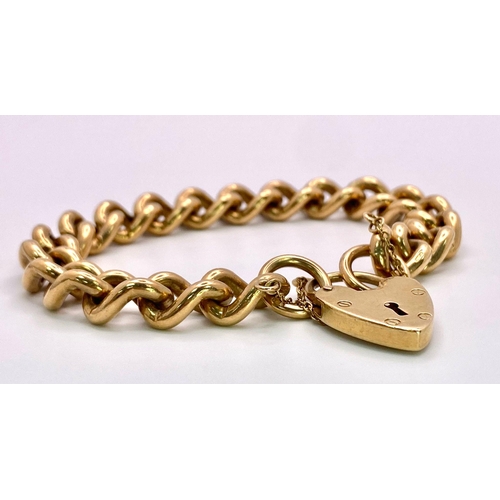 31 - A Vintage 9K Yellow Gold Chunky Curb Link Bracelet with a Heart Clasp. 58g total weight. 17cm.