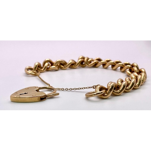 31 - A Vintage 9K Yellow Gold Chunky Curb Link Bracelet with a Heart Clasp. 58g total weight. 17cm.