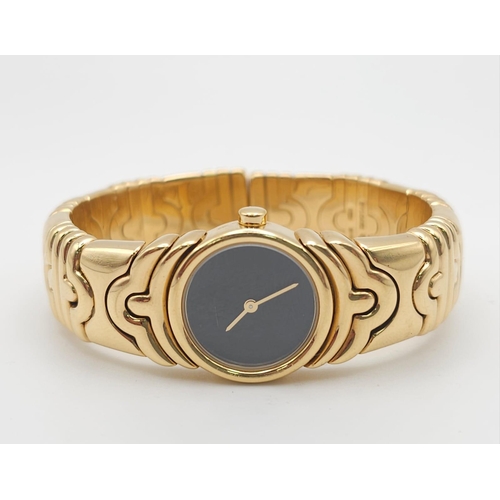 68 - A Bulgari Parentesi 18K Gold Ladies Watch. 18k gold decorative torque bracelet. 18k gold circular ca... 