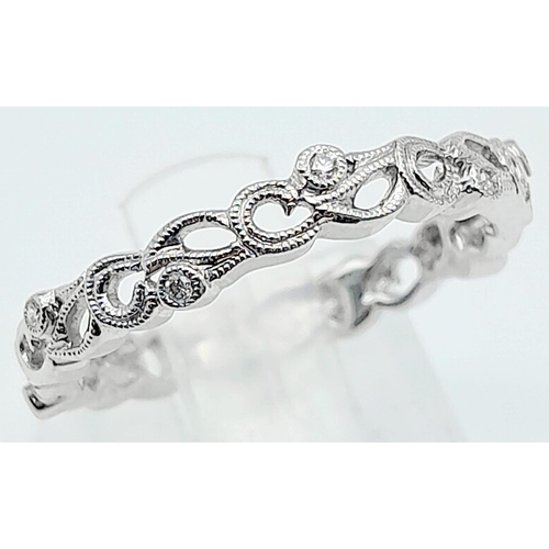 877 - A 9KT White Gold, Diamond Set Ring.
With unique, scrolling design.
Size: L
Weight: 1.92g