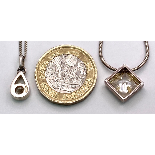 1454 - 2X 925 silver Cubic Zirconia pendants on silver chains. Total weight 9.72G. Both have length of 46cm