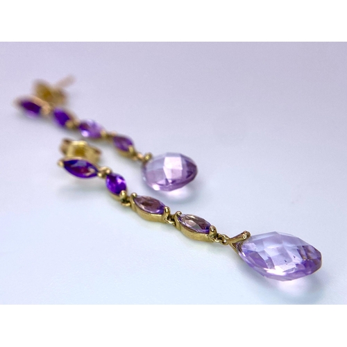 1514 - A Pair of 9K Yellow Gold Amethyst Drop Earrings. 4cm drop.
2.22g total weight.